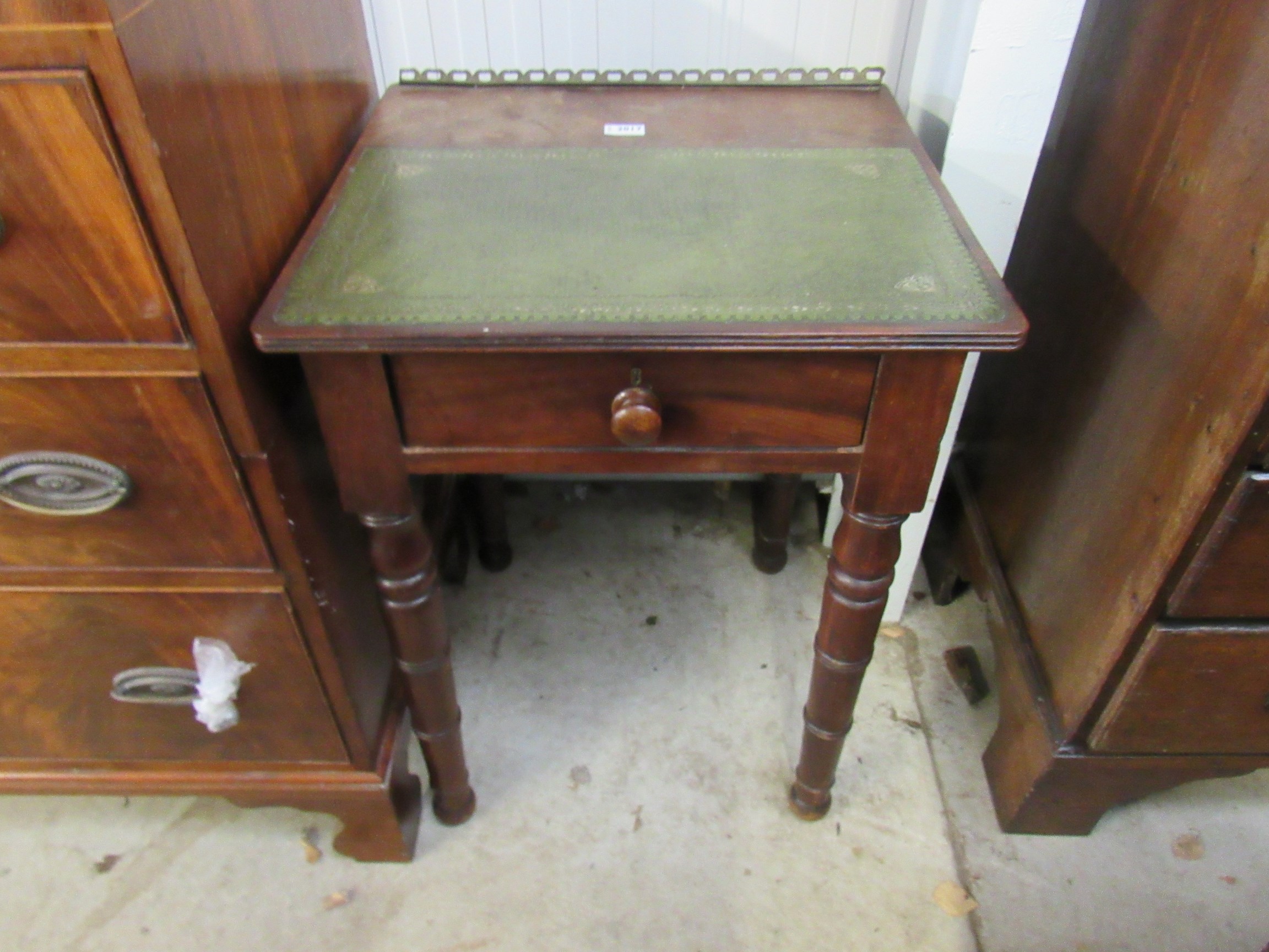 A small Georgian mahogany desk with green leather top and gilt brass gallery over a single drawer