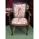 An Edwardian ladies elbow chair, the scroll arms over cabriole legs and turned "H" stretcher,