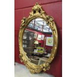 A gilt & gesso oval mirror with cherub detail,