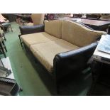 An early 20th century leather club sofa with carved frame loose cushions,