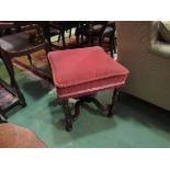 Circa 1840 a walnut stool the concave edged seat over turned legs joined by an 'X' stretcher with