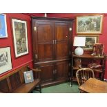 A Georgian oak four door corner cupboard with shaped shelf interior to top,