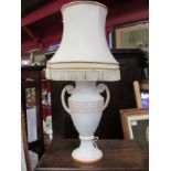 A ceramic twin handled table lamp with shade