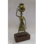 An African brass figure of woman carrying a water vessel on her head,