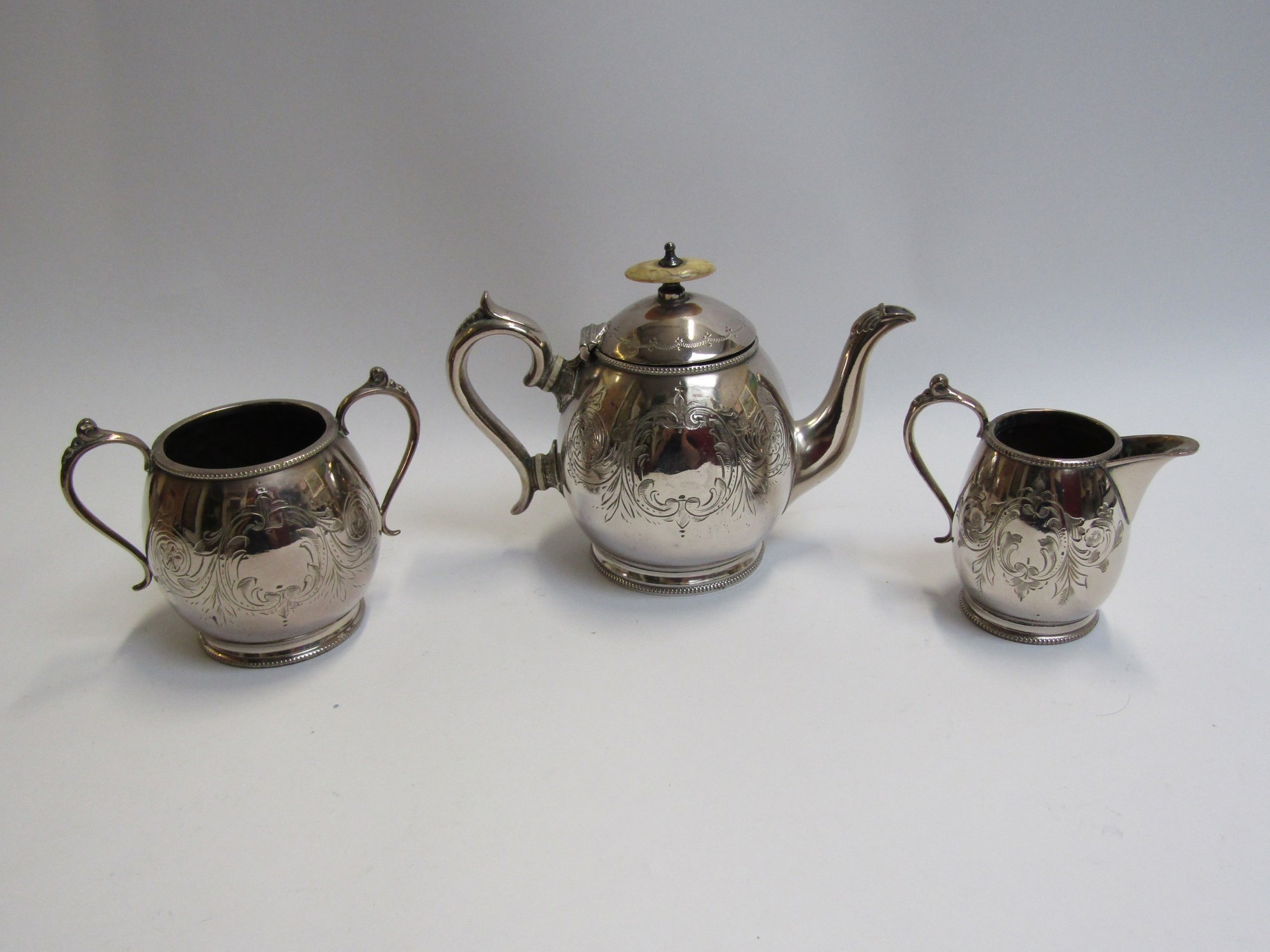 A silver plate three piece tea set and candlestick - Image 3 of 3