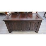 A circa 1700 panelled oak coffer with lidded internal candle box and carved lozenge decoration over