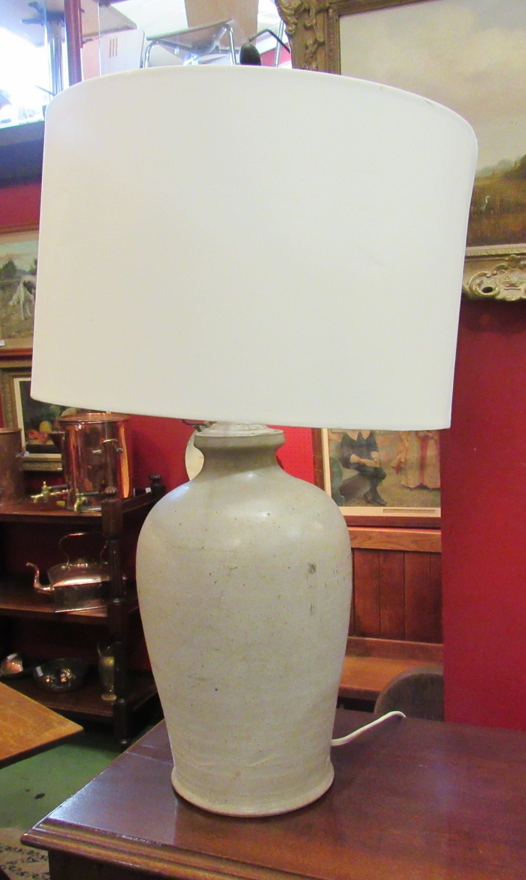 A stoneware lamp with shade,