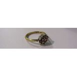 A 9ct gold ring set with three rubies enclosed by six individually set diamonds. Size O/P, 2.