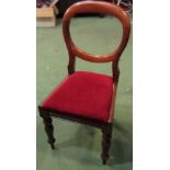 A set of six Victorian mahogany balloon back dining chairs on turned and tapering legs