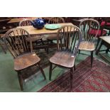 Five similar late 19th Century elm seated stick back chairs with V-support to backs and 'H'