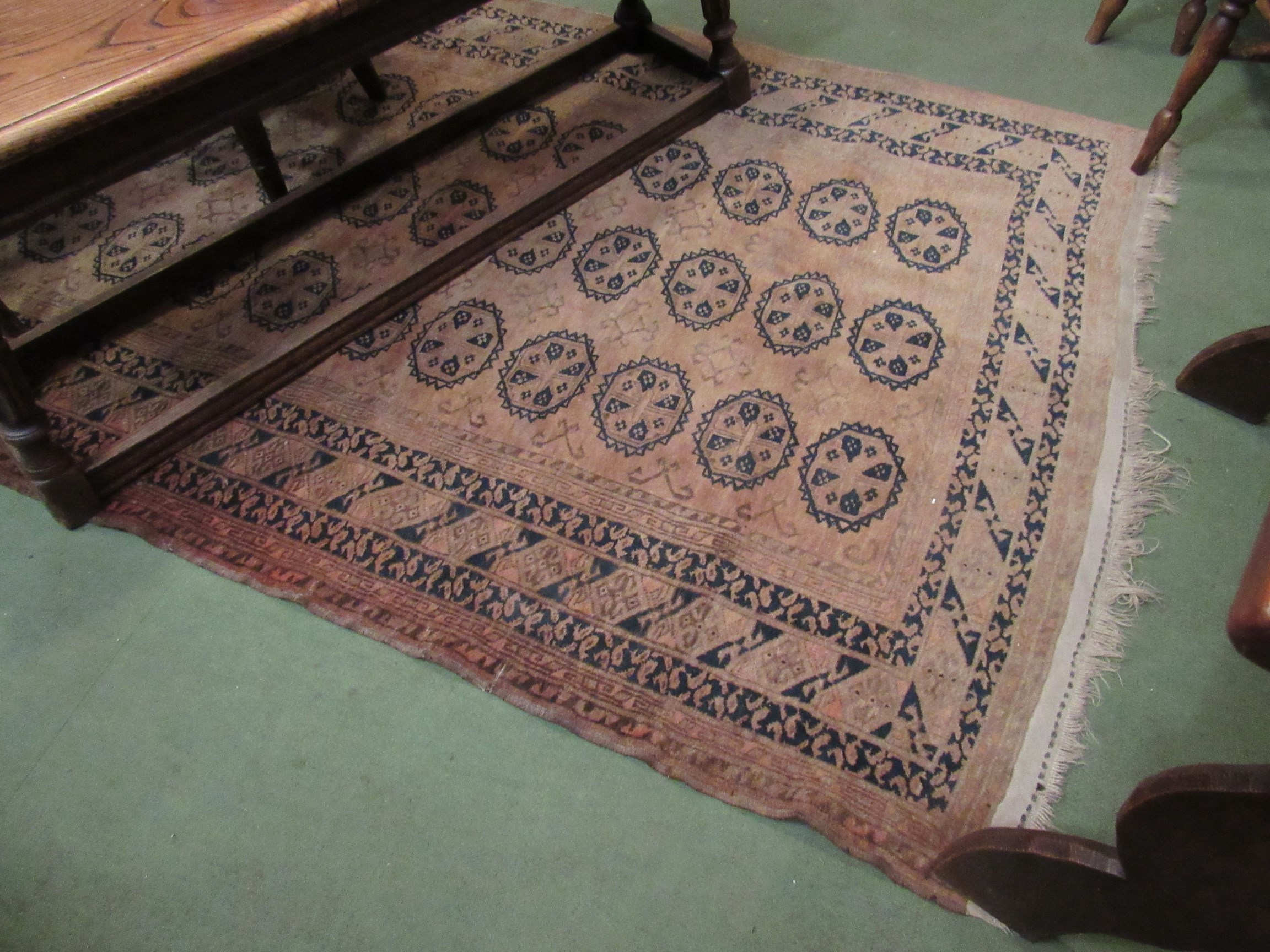 An Eastern brown geometric tasselled rug,
