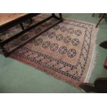 An Eastern brown geometric tasselled rug,