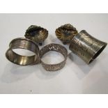 A pair of silver scallop-shell shaped salts and three various silver napkin rings (5)
