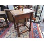 An oak joined stool on turned legs joined by stretchers,