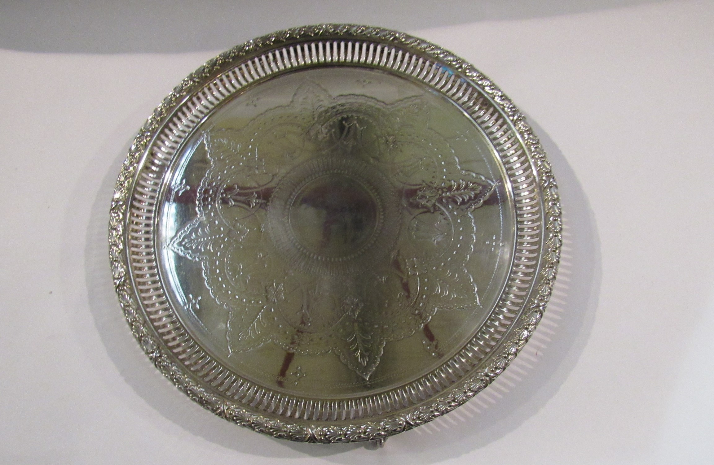 An ornate electroplated salver with pierced border,