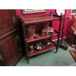 A Victorian mahogany three tier buffet with melon fluted finials on castors,