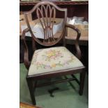 A George III mahogany shield back elbow chair with fretwork central back splat over a needlepoint