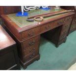 A Georgian style mahogany twin pedestal writing desk the tooled leather writing surface over nine