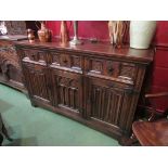 A Titchmarsh & Goodwin 18th Century style carved oak dresser base with Gothic tracery and linen