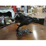 A limited edition solid bronze hare at full pelt,