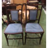 A pair of Edwardian inlaid mahogany chairs with blue upholstery