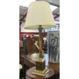 A brass column form lamp with shade