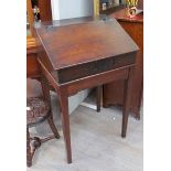 An early 18th Century oak desk on stand the rising slope and shelf interior over square tapering