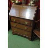An Edwardian crossbanded mahogany ladies bureau the fitted interior over three drawers and bracket