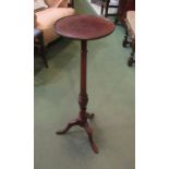 A George III style mahogany wine table the dished circular top on a turned column and tripod base,