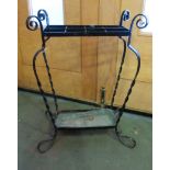 A wrought metal black painted stick stand with scroll detail and drip tray,