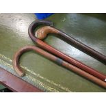 Three walking canes including leather handled