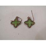 A pair of jade coloured quatrefoil earrings in coloured mounts,