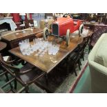 A 19th Century French walnut extending dining table with two extra leaves over turned and