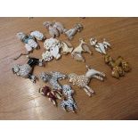 12 poodle brooches including celluloid,