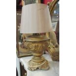 An ormolu table lamp base with classical putti design,