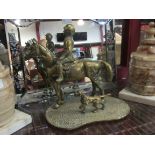 A heavy brass figure of a horse accompanied by a dog,