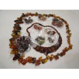 A collection of amber beads necklaces and earrings and similar tonal costume jewellery