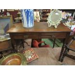 Circa 1900 a walnut writing desk with two frieze drawers on ring turned tapering legs and brass