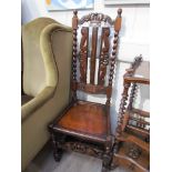 A pair of 17th Century revival oak upright hall chairs with carved coronet backrest and spiral