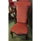 A circa 1840 walnut open armchair with carved decoration on scroll foot cabriole legs and brass