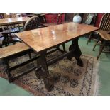 A small oak trestle table with shaped stretcher,
