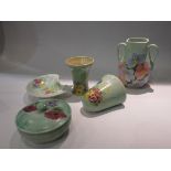 Five pieces of Radford pottery green ground with flower designs, covered box, wall pocket,