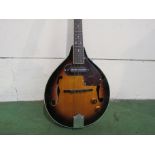 A Countryman mandolin of teardrop form, sunburst body with pickup and tortoiseshell pickguard,