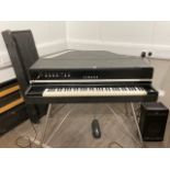 A Yamaha CP70b electric grand piano with foot pedal and separate PA amplifier