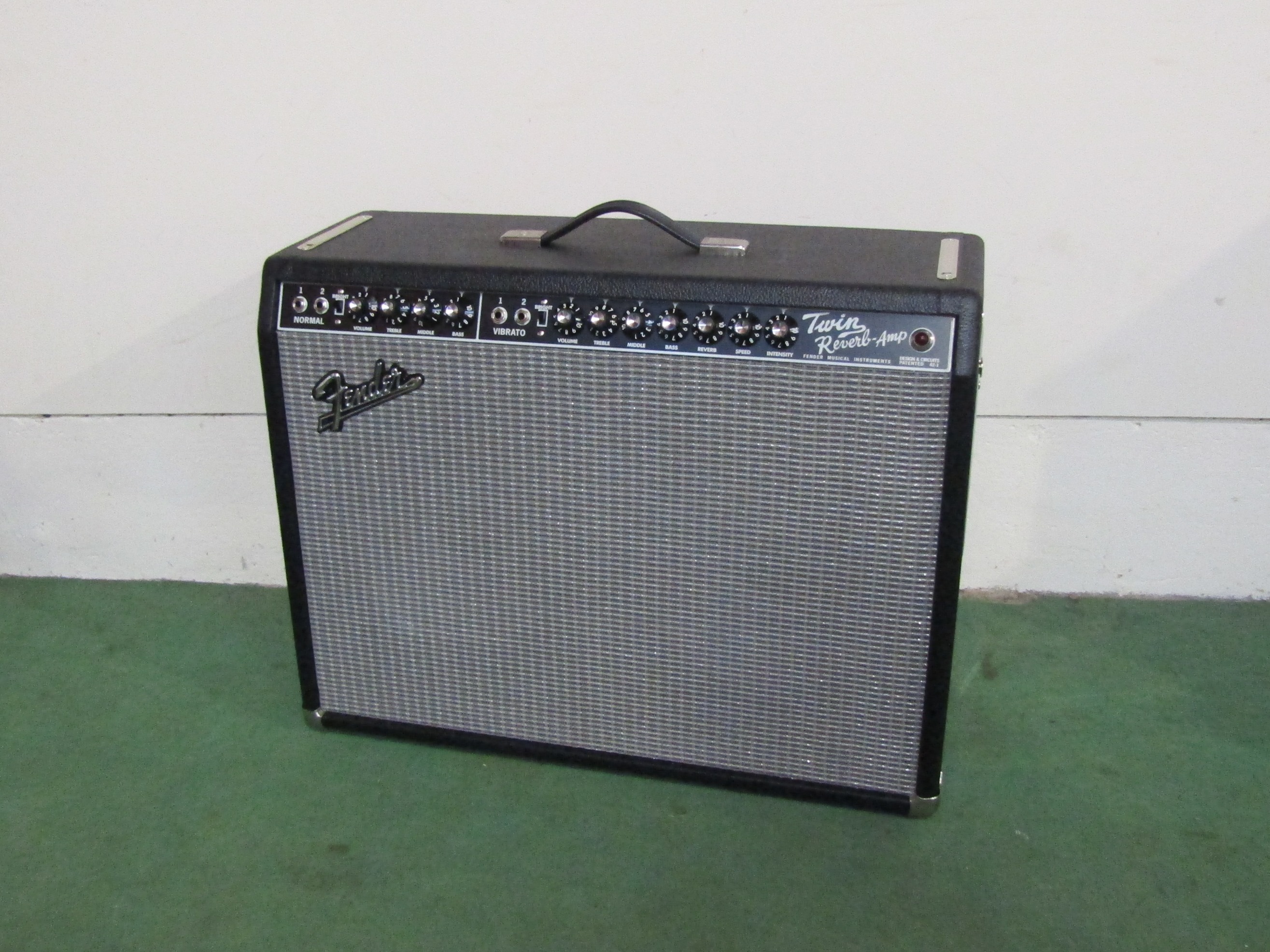 A Fender "65" Twin Reverb 85 watt amplifier with vibrato, reverb and foot switch.