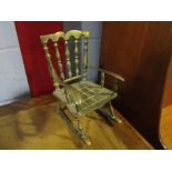 A brass miniature rocking chair