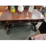 A circa 1830 rosewood library table the two frieze drawers on lion paw carved feet and castors,