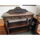 A circa 1880 carved oak 'Greenman' three tier serving table the raised back over two frieze drawers