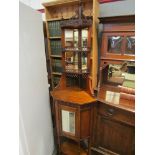 In the manner of Maple & Co a Victorian mahogany mirror back corner cabinet with turned finials and