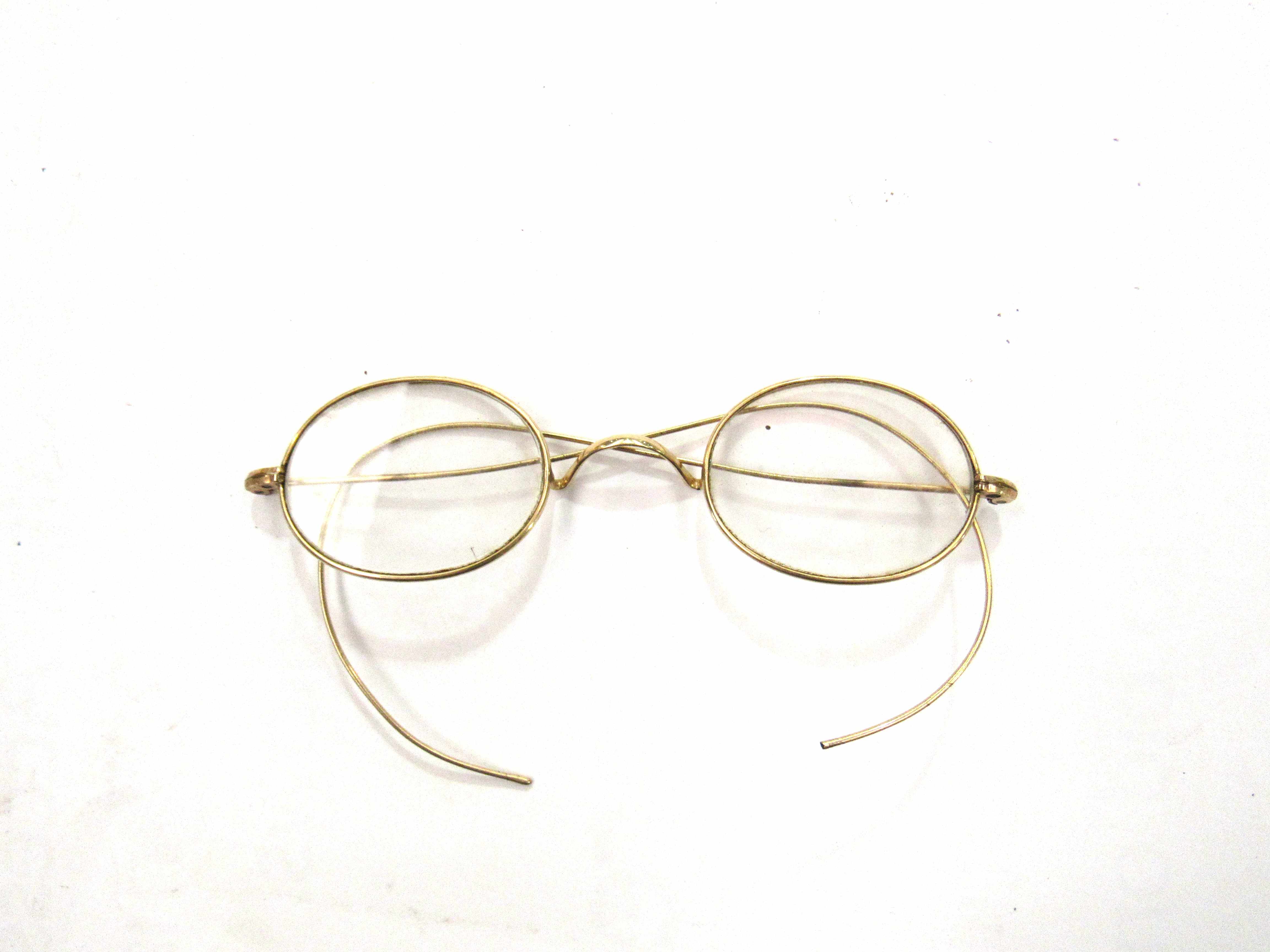 A pair of vintage yellow metal framed spectacles